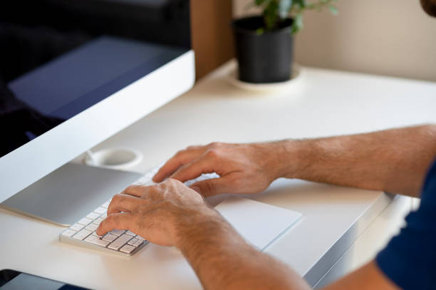 istock man sitting on the table and browsing the internet, working at home. USA 1309201500