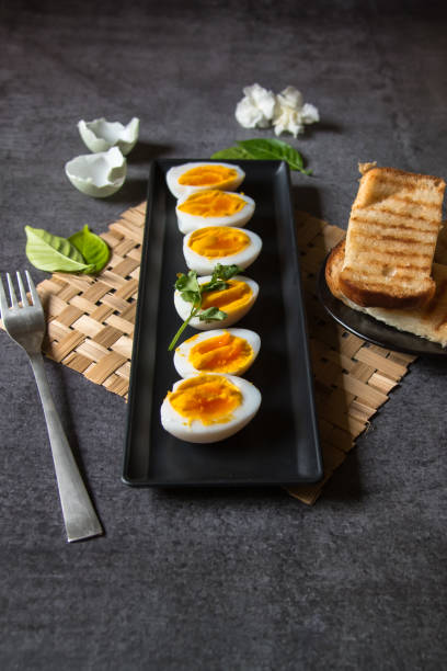 istock Boiled egg slices in a tray and breads 1309201608