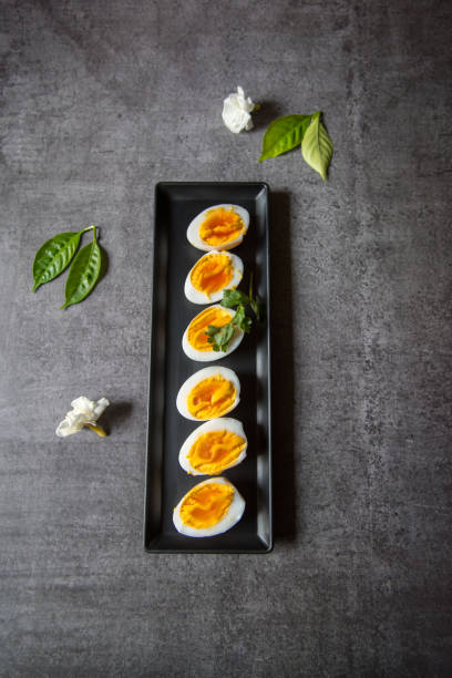 istock Top view of boiled egg slices in a tray 1309201614