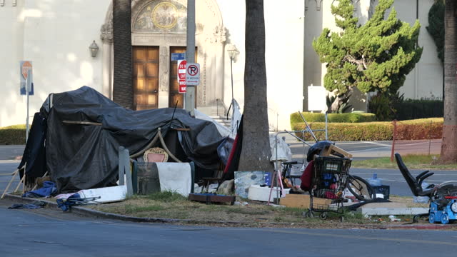 A homeless person’s tent and possessions on a traffic island in the city