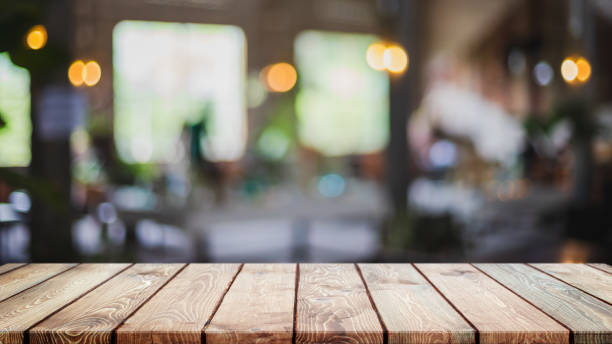 istock Empty wood table top and blurred coffee shop, cafe and restaurant interior background - can used for display or montage your products. 1309206251