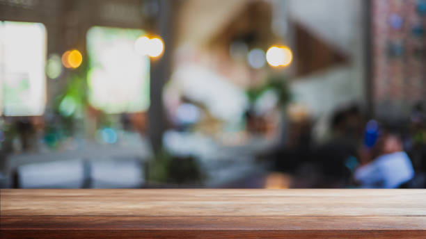 istock Empty wood table top and blurred coffee shop, cafe and restaurant interior background - can used for display or montage your products. 1309206261