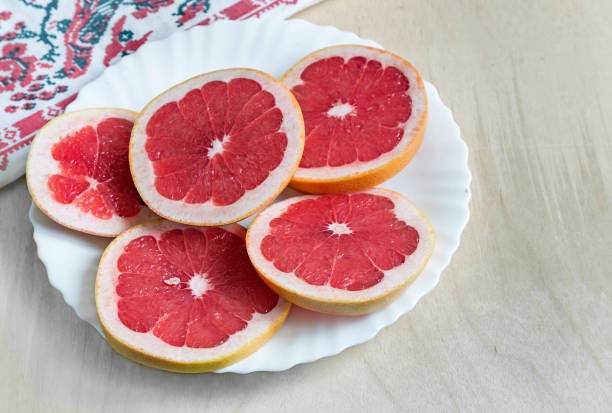 istock Sliced fruit of the grapefruit on the plate. 1309209022