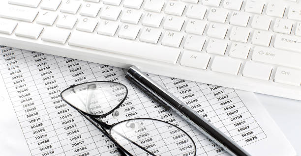 istock business work with chart,glasses, pen and keyboard on white office desk top view 1309209650