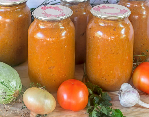 istock Canned squash caviar with vegetables in glass jars. 1309209846