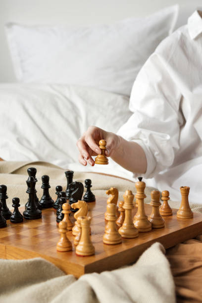 istock Chess Player Woman Hand. White Pawn Step Forward 1309211640