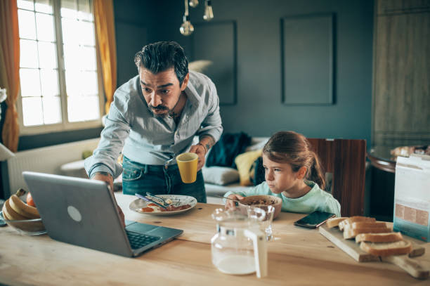 istock a father prepares breakfast for his daughter 1309213012