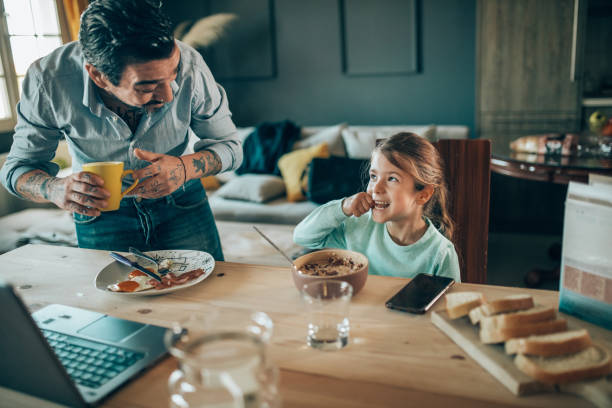 istock a father prepares breakfast for his daughter 1309213095