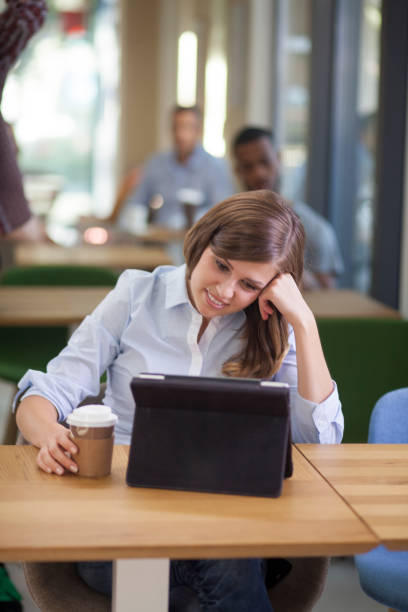 istock Young woman video conferencing in coffe shop 1309215281