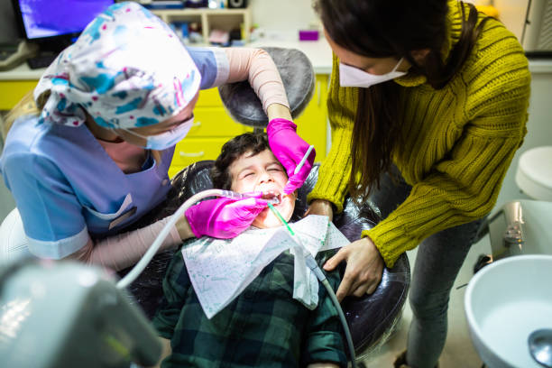 istock A boy fixing his tooth with his mom by his side 1309216013
