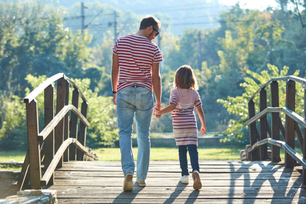 istock Daughter and father enjoying outdoors nature. 1309217289