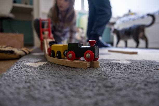 istock Kids playing in a room with a wooden train 1309217322