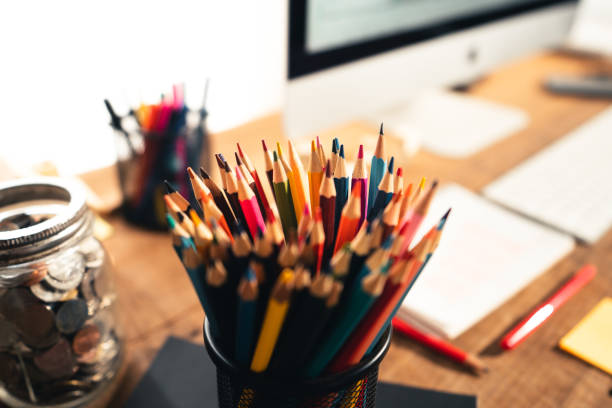 istock Colored pencil boxes on the wooden desk at home 1309220080