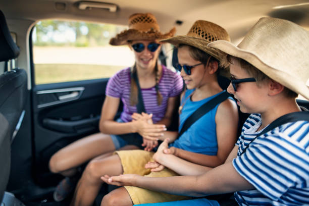istock Kids playing games while travelling by car 1309220673