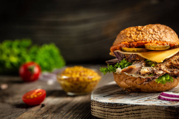 istock Hamburger with beef, cheese and vegetables on rustic table. fast food and junk food concept. copy space 1309220821