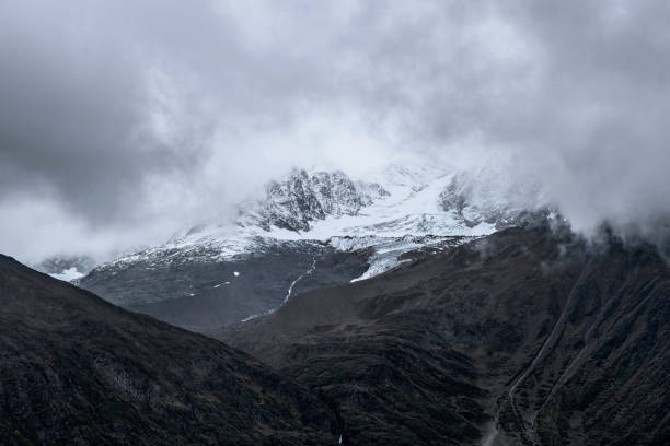 istock Snow-capped mountain in cloudy sky 1309222550