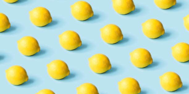 istock Pattern of ripe lemons on a blue background. 1309223601