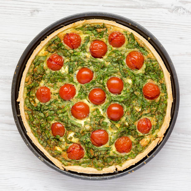 istock Homemade Spinach Quiche in a baking dish, top view. Flat lay, overhead, from above. Close-up. 1309226251