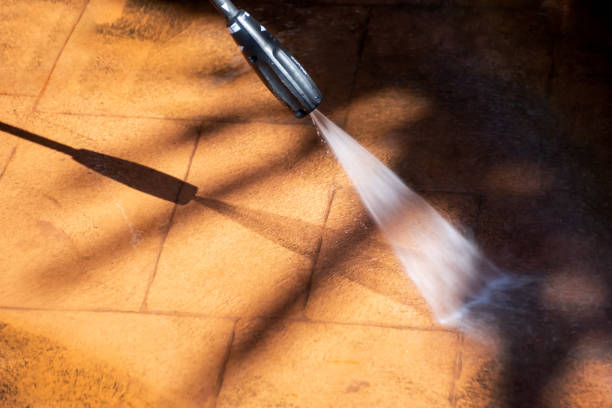 istock Cleaning backyard paving tiles with pressure washer. 1309227604