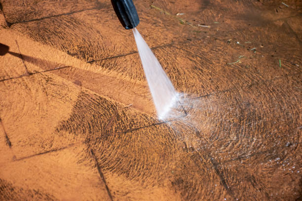 istock Cleaning backyard paving tiles with pressure washer. 1309227619