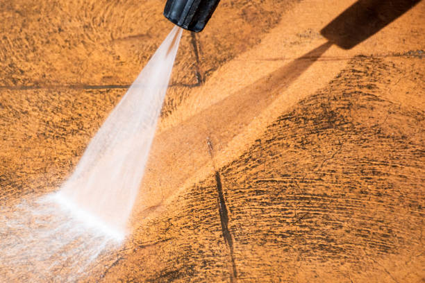 istock Cleaning backyard paving tiles with pressure washer. 1309227805