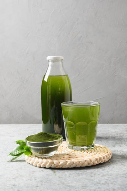 istock Chlorella Detox beverage with lemon in glass and bottle for day. 1309230387