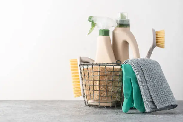 Photo of Brushes, sponges, rubber gloves and natural cleaning products in the basket