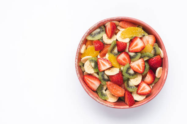 istock Fruit salad in pink bowl on white background 1309230462