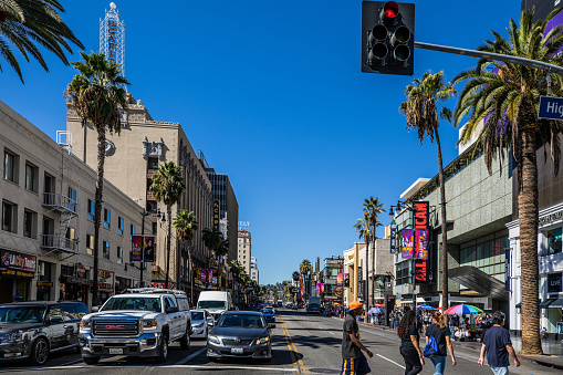 Los Angeles, California, USA - October 19, 2018: View of Hollywood city streets at day light in sunny day. Crowd of people crossing the street.
