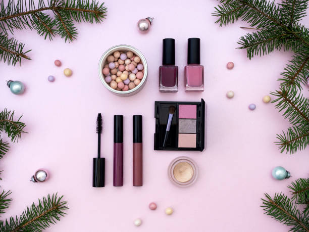 istock Flat lay composition with makeup cosmetic products and Christmas decor on pink background. Top view. Beauty banner for sale 1309232181