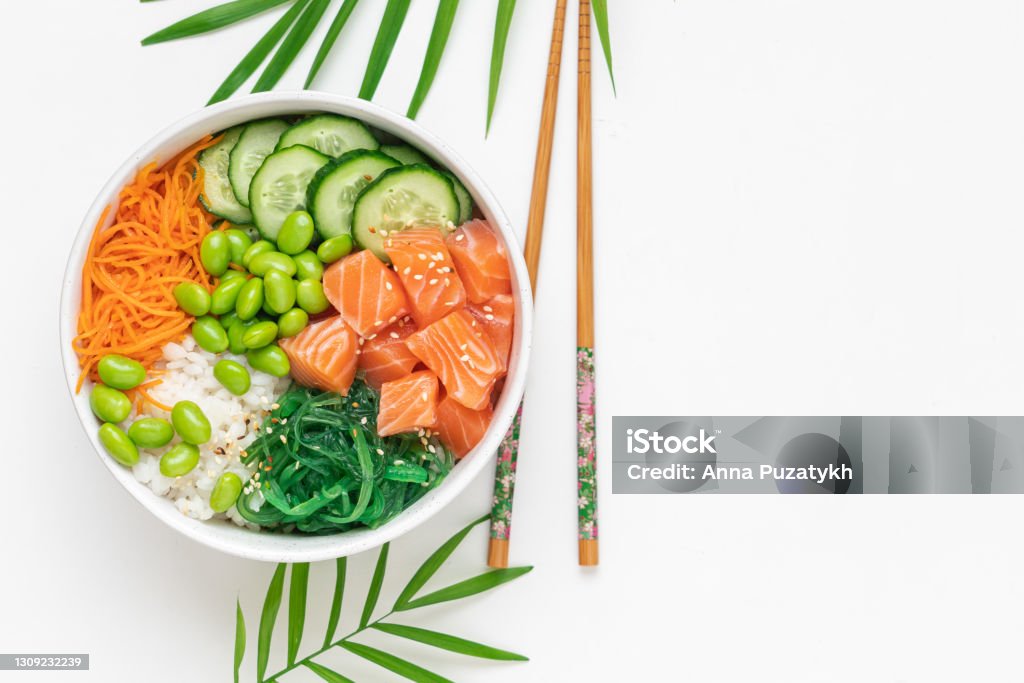Poké bowl with raw salmon Bowl with raw fish, rice, chukka salad, edamame beans, carrots and cucumber. Bowl of healthy food on white background Bowl Stock Photo