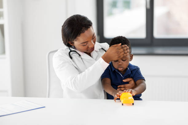 istock doctor with measuring baby's temperature at clinic 1309233218