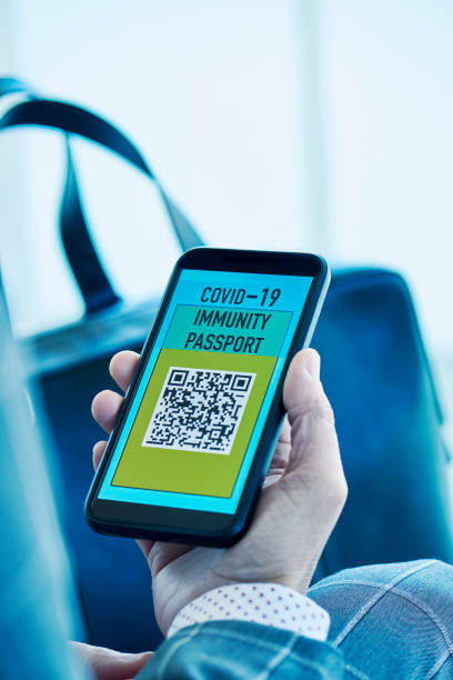 istock man with an electronic covid-19 immunity passport 1309234086
