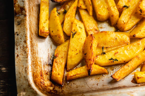 istock Sliced grilled potatoes with spices and herbs on the pan. Selective focus. Shallow depth of field. 1309234787