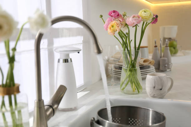 istock Light kitchen decorated with beautiful fresh ranunculus flowers 1309237060