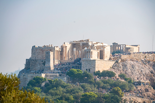 Tourists on the acropolis of Athens taken late summer 2019.\n\nAthens is the capital and largest city in the the Attica region of Greece. The Parthenon is a former temple on the Athenian Acropolis, Greece, dedicated to the goddess Athena, whom the people of Athens considered their patron.