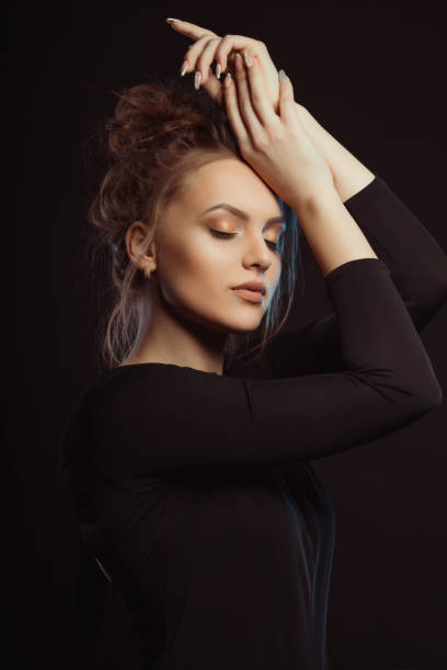 istock Dramatic portrait of beautiful model in the shadows 1309239540