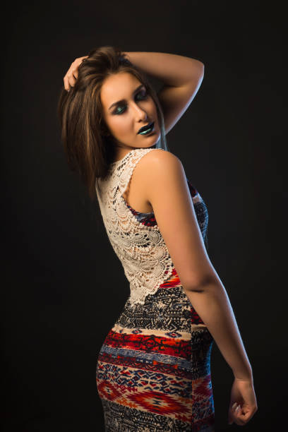 istock Attractive young woman with dark makeup and blue studio light 1309239611