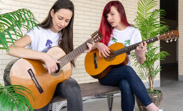 istock Female guitarists talking during music session 1309240033