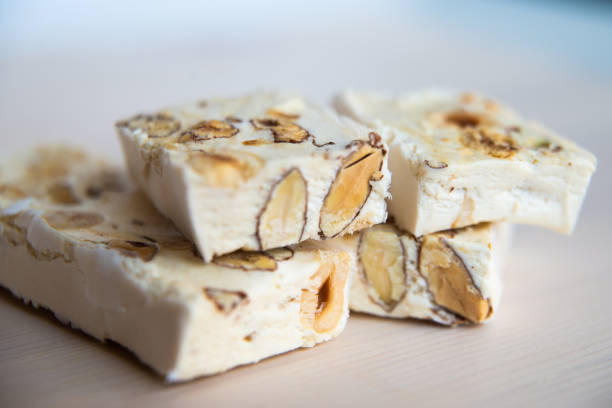 istock Pieces of soft nougat on white cutting board 1309242271