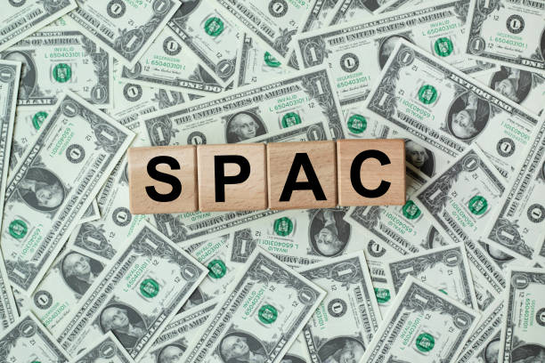 spac, special purpose acquisition company symbol. wooden cubes with word 'spac' on beautiful background from dollar bills, copy space. business and spac, special purpose acquisition company concept. - stock market data insurance savings finance imagens e fotografias de stock