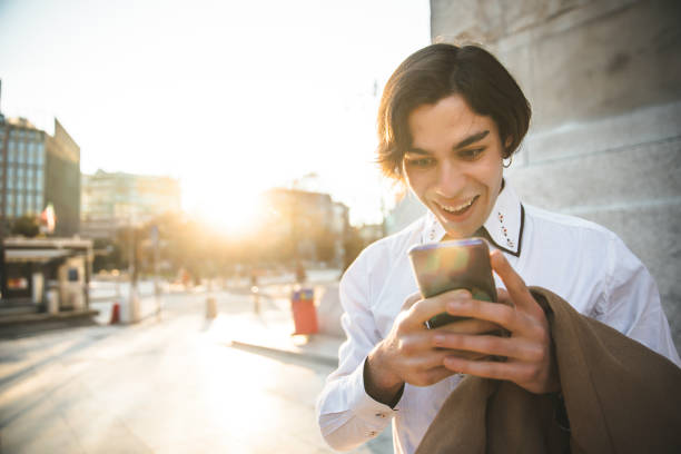 istock Smiling handsome businessman using smart phone 1309243755