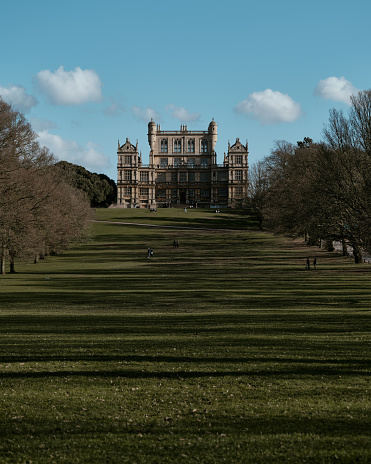 Nottingham, England - March,15,2021: Photo of Wollaton Hall on a sunny spring afternoon. Wollaton Hall and the grounds that surround it are popular for walkers and people wanting to enjoy a day out. The Hall is an Elizabethan country house of the 1580s and was used by Warner Bros as the set of Wayne Manor in the 2012 Batman film, The Dark Knight Rises.