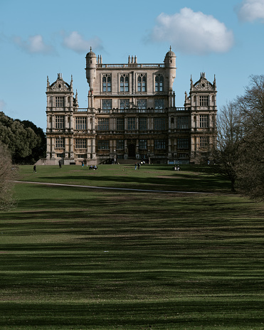 Nottingham, England - March,15,2021: Photo of Wollaton Hall on a sunny spring afternoon. Wollaton Hall and the grounds that surround it are popular for walkers and people wanting to enjoy a day out. The Hall is an Elizabethan country house of the 1580s and was used by Warner Bros as the set of Wayne Manor in the 2012 Batman film, The Dark Knight Rises.