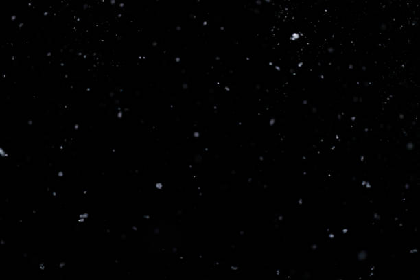 istock Real falling snow on black background for blending modes in ps. Ver 01 - few snowflakes in blur 1309244165
