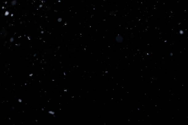 istock Real falling snow on black background for blending modes in ps. Ver 03 - few snowflakes 1309244166