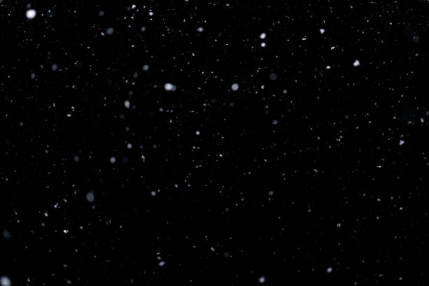 istock Real falling snow on black background for blending modes in ps. Ver 09 - few snowflakes in blur 1309244169