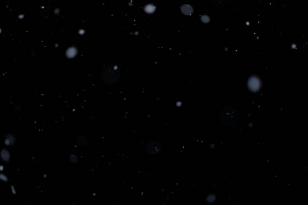istock Real falling snow on black background for blending modes in ps. Ver 04 - few snowflakes in blur 1309244170