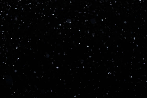 istock Real falling snow on black background for blending modes in ps. Ver 06 - few snowflakes in blur 1309244171