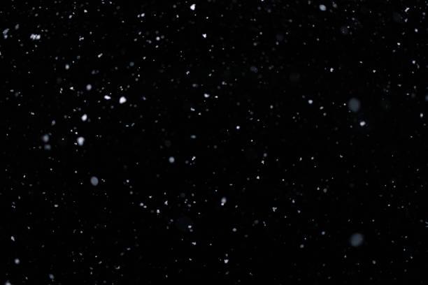 istock Real falling snow on black background for blending modes in ps. Ver 07 - few snowflakes in blur 1309244173
